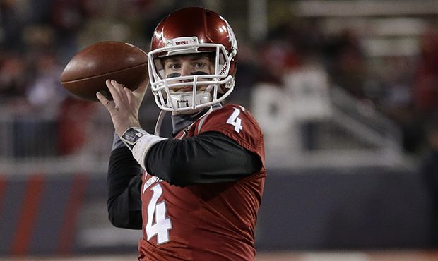Washington State quarterback Luke Falk passes during warmups before an NCAA college football game a...