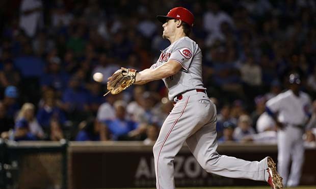 Cincinnati Reds second baseman Scooter Gennett pitches in a relief roll during the eighth inning of...