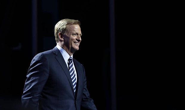 NFL Commissioner Roger Goodell smiles as he walks onstage during the first round of the 2017 NFL fo...
