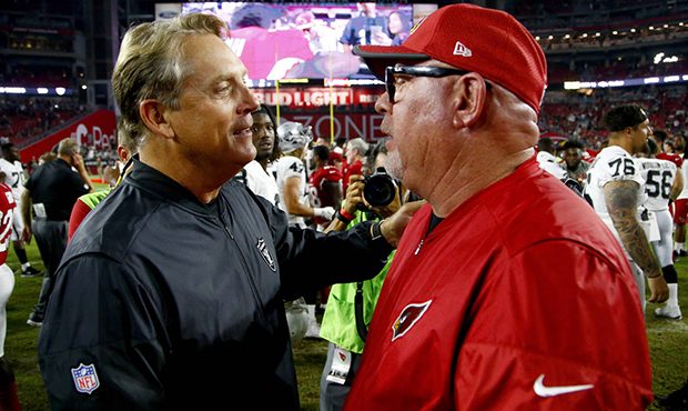 Arizona Cardinals coach Bruce Arians, right, greets Oakland Raiders coach Jack Del Rio after an NFL...