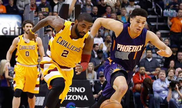 Cleveland Cavaliers' Kyrie Irving (2) steals the basketball from Phoenix Suns' Devin Booker (1) as ...