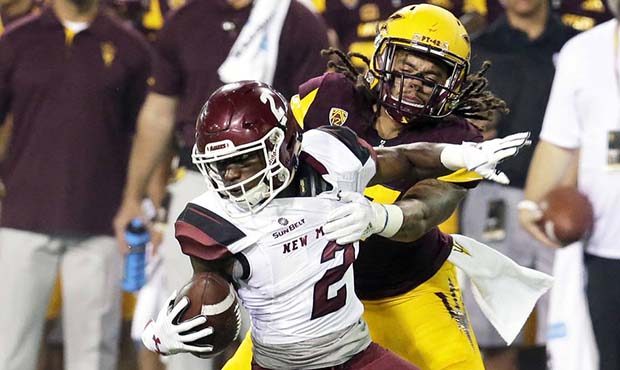 New Mexico State wide receiver OJ Clark (2) gets tackled by Arizona State defensive back J'Marcus R...