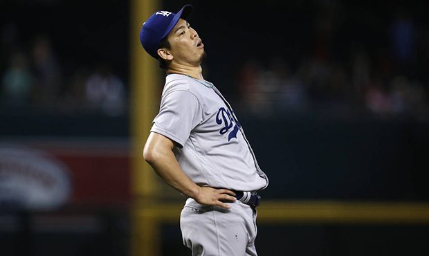 Los Angeles Dodgers' Kenta Maeda watches a two-run home run hit by Arizona Diamondbacks' A.J. Pollo...
