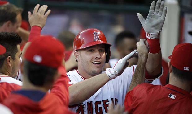 Los Angeles Angels' Mike Trout is greeted by teammates after hitting a two-run home run during the ...