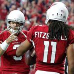 Arizona Cardinals quarterback Carson Palmer (3) points to wide receiver Larry Fitzgerald (11) after a touchdown catch during the first half of an NFL football game against the Green Bay Packers, Sunday, Dec. 27, 2015, in Glendale, Ariz. (AP Photo/Ross D. Franklin)