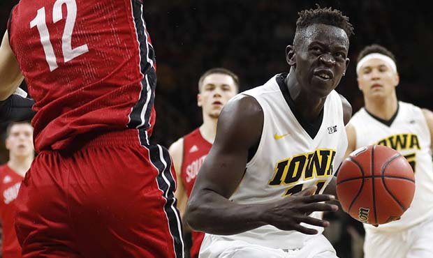 Iowa guard Peter Jok, right, drives to the basket in front of South Dakota forward Trey Burch-Manni...