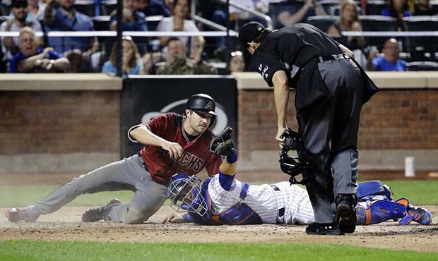 New York Mets catcher Travis d'Arnaud (18) shows the umpire the ball after tagging out Arizona Diam...