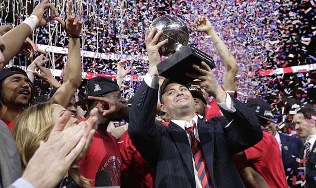 Arizona coach Sean Miller holds up the trophy after Arizona defeated Oregon 83-80 in an NCAA colleg...