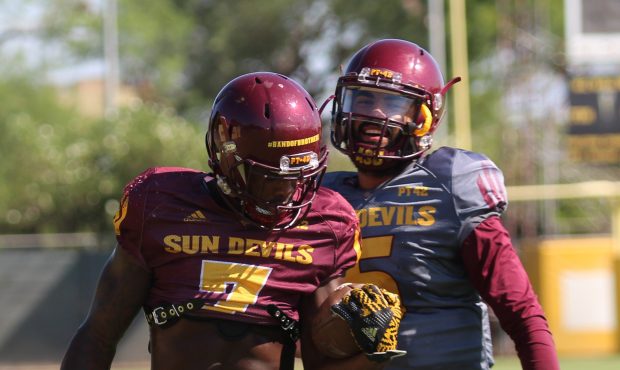 Manny Wilkins and Kalen Ballage share a laugh during practice. 
(Photo by Joshua Clark/Cronkite New...