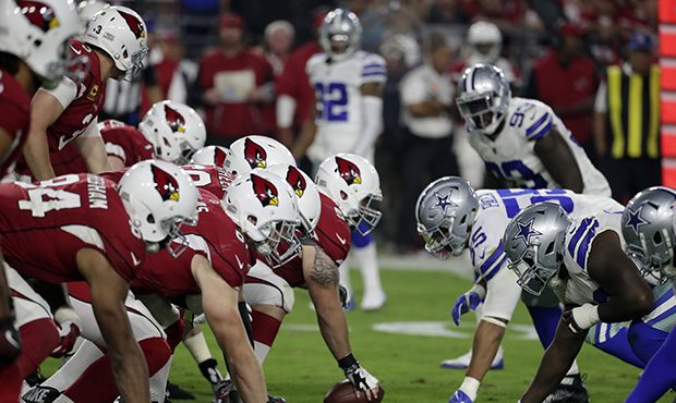 The Dallas Cowboys and the Arizona Cardinals line up during the second half of an NFL football game...