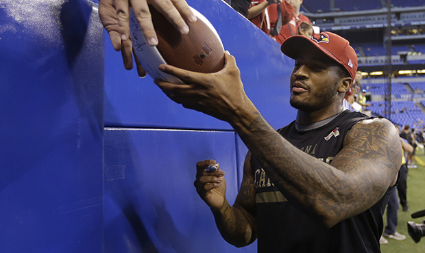 Arizona Cardinals' Deone Bucannon signs autographs for fans before an NFL football game against the...