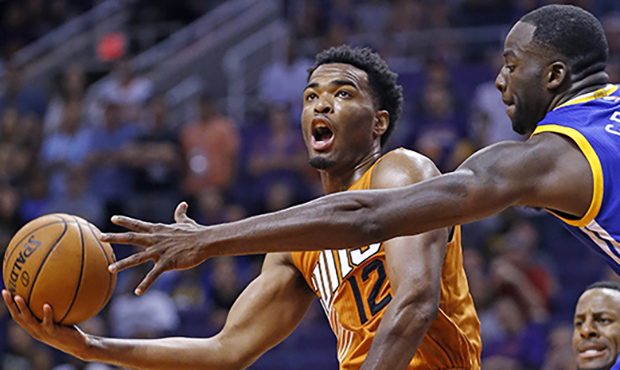 Phoenix Suns forward T.J. Warren (12) tries to get off a shot as Golden State Warriors forward Dray...