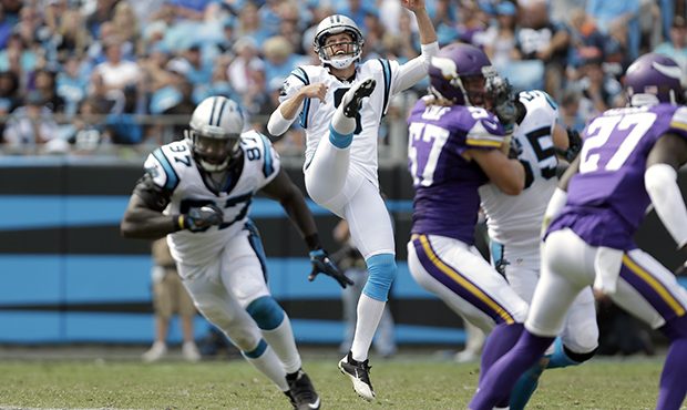Carolina Panthers' Andy Lee (8) watches his punt sail over to the Minnesota Vikings during the seco...