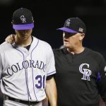 Colorado Rockies' Kyle Freeland (31) walks off the field with pitching coach Steve Foster, right, after Freeland was hit by a line drive hit by Arizona Diamondbacks' J.D. Martinez during the fourth inning of a baseball game, Monday, Sept. 11, 2017, in Phoenix. (AP Photo/Ross D. Franklin)