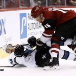 Arizona Coyotes' Max Domi (16) and San Jose Sharks' Dylan DeMelo (74) battle for the puck during the third period of a preseason NHL hockey game Saturday, Sept. 23, 2017, in Glendale, Ariz. The Sharks defeated the Coyotes 5-4 in a shootout. (AP Photo/Ross D. Franklin)