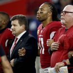 From left; Arizona Cardinals cornerback Patrick Peterson, president Michael Bidwill, wide receiver Larry Fitzgerald and head coach Bruce Arians stand during the national anthem prior to an NFL football game against the Dallas Cowboys, Monday, Sept. 25, 2017, in Glendale, Ariz. (AP Photo/Ross D. Franklin)