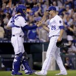 Kansas City Royals catcher Cam Gallagher, left, and relief pitcher Mike Minor (26) celebrate after a baseball game against the Arizona Diamondbacks, Saturday, Sept. 30, 2017, in Kansas City, Mo. (AP Photo/Charlie Riedel)