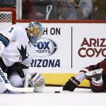 San Jose Sharks' Troy Grosenick (1) makes a save on a shot by Arizona Coyotes' Clayton Keller, right, during the shootout in a preseason NHL hockey game Saturday, Sept. 23, 2017, in Glendale, Ariz. The Sharks defeated the Coyotes 5-4 in a shootout. (AP Photo/Ross D. Franklin)