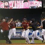 Arizona Diamondbacks' J.D. Martinez (28) celebrates his walk off single as David Peralta (6) celebrates with other teammates after clinching a National League wild card playoff spot in a baseball game against the Miami Marlins, Sunday, Sept. 24, 2017, in Phoenix. The Diamondbacks defeated the Marlins 3-2. (AP Photo/Ross D. Franklin)