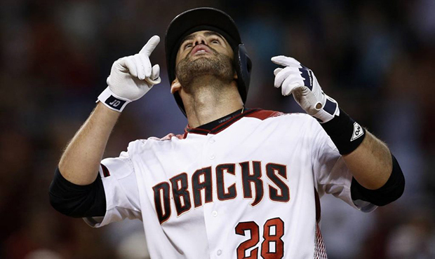 Arizona Diamondbacks' J.D. Martinez looks and points to the sky after hitting a home run against th...