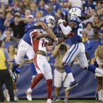Indianapolis Colts' Malik Hooker (29) makes an interception on a pass intended for Arizona Cardinals' J.J. Nelson (14), center, during the first half of an NFL football game Sunday, Sept. 17, 2017, in Indianapolis. At left is Colts cornerback Quincy Wilson (31). (AP Photo/AJ Mast)