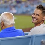 Actor Rob Lowe, right, sits with former Los Angeles Dodgers manager Tommy Lasorda during a baseball game between the Dodgers and the Arizona Diamondbacks, Tuesday, Sept. 5, 2017, in Los Angeles. (AP Photo/Mark J. Terrill)
