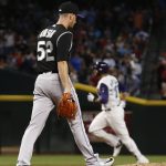 Colorado Rockies' Chris Rusin (52) walks back on the mound after giving up a home run to Arizona Diamondbacks' J.D. Martinez, right, during the third inning of a baseball game Thursday, Sept. 14, 2017, in Phoenix. (AP Photo/Ross D. Franklin)