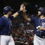 San Diego Padres' Jordan Lyles, right, smiles as he high-fives Austin Hedges, left, after they scored against the Arizona Diamondbacks during the fourth inning of a baseball game Friday, Sept. 8, 2017, in Phoenix. (AP Photo/Ross D. Franklin)