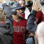 Arizona Diamondbacks' David Peralta is congratulated in the dugout after hitting a home run during the first inning of a baseball game against the San Diego Padres, Wednesday, Sept. 20, 2017, in San Diego. (AP Photo/Orlando Ramirez)