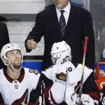 Arizona Coyotes' head coach Rick Tocchet, centre, gives instruction to players during the first period of a preseason NHL hockey game against the Calgary Flames, Friday, Sept. 22, 2017 in Calgary, Alberta. (John McIntosh/The Canadian Press via AP)