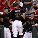 Arizona Diamondbacks' Brandon Drury (27) high-fives manager Torey Lovullo, right, and David Peralta after hitting a solo home run against the Miami Marlins during the second inning of a baseball game, Saturday, Sept. 23, 2017, in Phoenix. (AP Photo/Matt York)