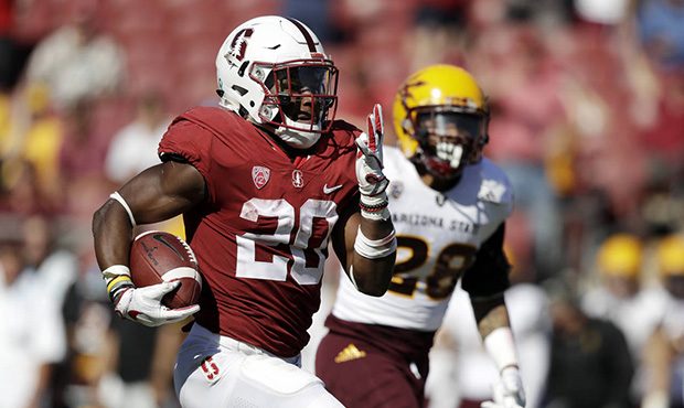 Stanford running back Bryce Love, left, runs for a touchdown past Arizona State defensive back Demo...