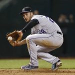 Colorado Rockies' Nolan Arenado gets his glove on a grounder hit by Arizona Diamondbacks' Chris Iannetta before throwing to first base for the out during the eighth inning of a baseball game Tuesday, Sept. 12, 2017, in Phoenix. The Rockies defeated the Diamondbacks 4-2. (AP Photo/Ross D. Franklin)