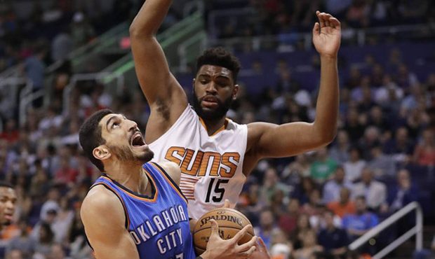 Oklahoma City Thunder center Enes Kanter falls as Phoenix Suns forward Alan Williams (15) defends d...