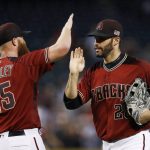 Arizona Diamondbacks' Archie Bradley (25) gives a high-five to Arizona Diamondbacks' J.D. Martinez, right, after the final out of a baseball game against the San Diego Padres, Sunday, Sept. 10, 2017, in Phoenix. The Diamondbacks defeated the Padres 3-2. (AP Photo/Ross D. Franklin)