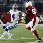 Dallas Cowboys quarterback Dak Prescott (4) trees to elude Arizona Cardinals defensive end Frostee Rucker (92) during the second half of an NFL football game, Monday, Sept. 25, 2017, in Glendale, Ariz. (AP Photo/Ross D. Franklin)