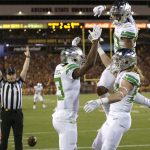 Oregon wide receiver Dillon Mitchell (13) celebrates with Johnny Johnson III (80) and Casey Eugenio after scoring a touchdown against Arizona State during the first half of an NCAA college football game, Saturday, Sept. 23, 2017, in Tempe, Ariz. (AP Photo/Rick Scuteri)