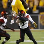 San Diego State's Trey Lomax (3) makes a tackle as Arizona State running back Kalen Ballage, top, tries to hurdle Lomax, while San Diego State's Jay Henderson (46) watches during the first half of an NCAA college football game Saturday, Sept. 9, 2017, in Tempe, Ariz. (AP Photo/Ross D. Franklin)