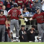 Arizona Diamondbacks' Jake Lamb is congratulated at the dugout by Chris Herrmann after hitting a home run during the second inning of a baseball game against the San Diego Padres Wednesday, Sept. 20, 2017, in San Diego. (AP Photo/Orlando Ramirez)