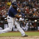 San Diego Padres' Manuel Margot connects for a two-run triple against the Arizona Diamondbacks during the fourth inning of a baseball game Friday, Sept. 8, 2017, in Phoenix. (AP Photo/Ross D. Franklin)