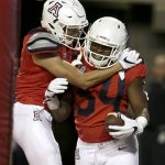Arizona running back Zach Green (34) celebrates with Shawn Poindexter (19) in the second half during an NCAA college football game against Northern Arizona, Saturday, Sept. 2, 2017, in Tucson, Ariz. (AP Photo/Rick Scuteri)