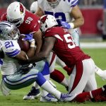 Dallas Cowboys running back Ezekiel Elliott (21) is hit by Arizona Cardinals nose tackle Corey Peters (98) and outside linebacker Chandler Jones (55) during the first half of an NFL football game, Monday, Sept. 25, 2017, in Glendale, Ariz. (AP Photo/Rick Scuteri)