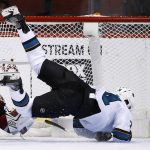 San Jose Sharks' Dylan DeMelo, right, flips over Arizona Coyotes' Marek Langhamer during overtime of a preseason NHL hockey game Saturday, Sept. 23, 2017, in Glendale, Ariz. The Sharks defeated the Coyotes 5-4 in a shootout. (AP Photo/Ross D. Franklin)
