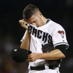 Arizona Diamondbacks' Patrick Corbin wipes sweat from his face on his way to giving up six runs to the San Diego Padres during the fourth inning of a baseball game Friday, Sept. 8, 2017, in Phoenix. (AP Photo/Ross D. Franklin)