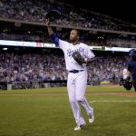 Kansas City Royals' Alcides Escobar acknowledges the crowd as he comes out of a baseball game during the seventh inning gainst the Arizona Diamondbacks, Saturday, Sept. 30, 2017, in Kansas City, Mo. (AP Photo/Charlie Riedel)