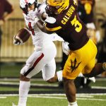 Texas Tech running back Justin Stockton is tackled by the face mask by Arizona State's D.J. Calhoon during the first half of an NCAA college football game Saturday, Sept. 16, 2017, in Lubbock, Texas. (Mark Rogers/Lubbock Avalanche-Journal via AP)