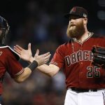 Arizona Diamondbacks' Archie Bradley (25) slaps hands with catcher Chris Hermann, left, after the final out of a baseball game against the San Diego Padres, Sunday, Sept. 10, 2017, in Phoenix. (AP Photo/Ross D. Franklin)