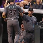 Arizona Diamondbacks' Brandon Drury (27) is congratulated by manager Torey Lovullo (17) after scoring on a Taijuan Walker RBI-single during the second inning of a baseball game against the colorado Rockies, Friday, Sept. 1, 2017, in Denver. (AP Photo/Jack Dempsey)