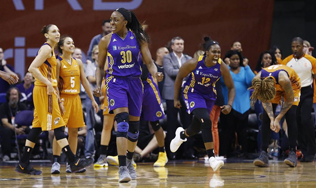 Los Angeles Sparks' Nneka Ogwumike (30) and Chelsea Gray (12) celebrate a win while Phoenix Mercury...