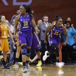Los Angeles Sparks' Nneka Ogwumike (30) and Chelsea Gray (12) celebrate a win while Phoenix Mercury's Diana Taurasi, left, Leilani Mitchell (5) and Brittney Griner, right, pause on the court as time expires in the second half of Game 3 of a WNBA basketball playoff semifinal Sunday, Sept. 17, 2017, in Phoenix. (AP Photo/Ross D. Franklin)